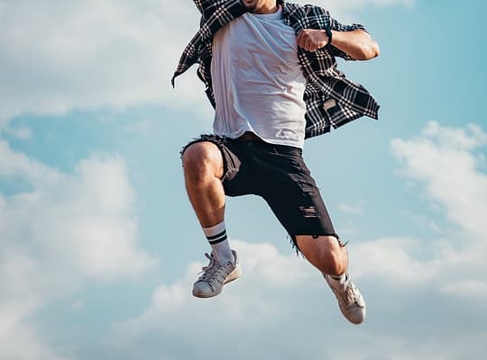 low angle photography of man jumping