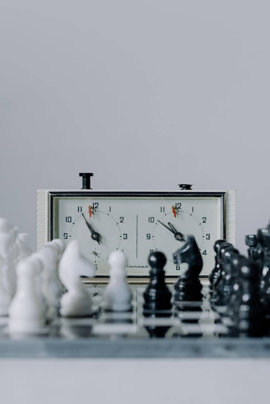 white and black chess pieces on a chess board